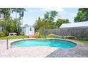 Private backyard pool featuring a brick patio, shed, lush greenery, and mature trees at 4424 19Th N St, St Petersburg, FL 33714