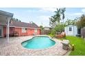 Relaxing backyard pool with a brick patio, shed, and comfortable lounge seating at 4424 19Th N St, St Petersburg, FL 33714