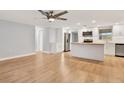 Open-concept kitchen with stainless steel appliances, island and modern design integrated with dining at 5200 Dove Dr, New Port Richey, FL 34652