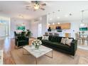 Open-concept living room flows to dining area and kitchen with hardwood floors and modern finishes at 5351 Lookout Pass, Wesley Chapel, FL 33544