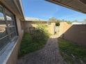 Inviting walkway leads through a gated entrance and landscaped garden area to the front door at 6120 Seabreeze Dr, Port Richey, FL 34668