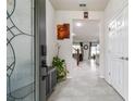 Bright foyer with tile flooring, decorative art, and an open view to the living spaces at 6228 Dutton Dr, Wesley Chapel, FL 33545