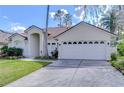 Charming single-story home featuring a well-maintained lawn, two-car garage, and tasteful landscaping at 6427 Weatherwood Cir, Wesley Chapel, FL 33545