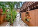 A cozy outdoor space showcasing a stone-paved walkway amidst lush greenery and plants at 799 Fairwood Ln, Clearwater, FL 33759
