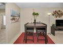 Dining area with modern table, chairs and bright lighting at 858 Cambridge Ct # 858, Dunedin, FL 34698