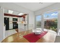 Dining area adjacent to a well-equipped kitchen, bathed in natural light, perfect for cozy meals and entertaining at 858 Cambridge Ct # 858, Dunedin, FL 34698