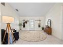 Spacious living room showcasing tile flooring, a decorative rug, and neutral-toned walls at 9550 134Th St, Seminole, FL 33776