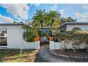 Inviting walkway that leads to the entrance, framed by tropical plants at 1214 Stover Ct, Holiday, FL 34691