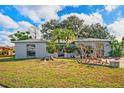 Charming home with a spacious front yard and mature trees at 1214 Stover Ct, Holiday, FL 34691