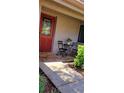Front entrance with red door, stone walkway, and stylish outdoor seating at 1102 Old Mill Pond Rd, Palm Harbor, FL 34683