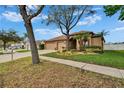 Charming single-story home featuring a well-maintained lawn, beautiful landscaping, and a two-car garage at 1220 Emerald Hill Way, Valrico, FL 33594