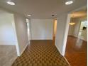 Bright entryway featuring unique flooring, neutral walls, and open sightlines into adjacent rooms at 13304 Meadowwood Ct, Tampa, FL 33618