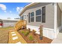 Charming single-story home with black shutters, a landscaped yard, and a cozy entrance at 14311 Action St, Brooksville, FL 34613