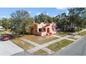 A charming, peach-colored house surrounded by mature trees in a residential neighborhood at 1900 17Th S St, St Petersburg, FL 33712