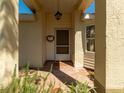 Cozy front porch featuring a decorative wreath and ample natural light at 2503 New Haven Cir, Sun City Center, FL 33573