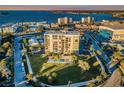 Stunning aerial view of a luxury condominium building overlooking the city and waterfront with pool at 2530 Gary Cir # 401, Dunedin, FL 34698