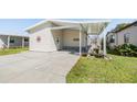 Charming home with a covered carport and well-maintained lawn, perfect for enjoying outdoor living at 3110 Moss Hill St, Wesley Chapel, FL 33543