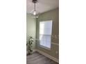 Bright dining room with modern light fixture, window, and neutral paint at 4237 Brentwood Park Cir, Tampa, FL 33624