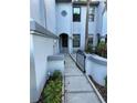 Inviting entryway with landscaped walkway and decorative gate at 4237 Brentwood Park Cir, Tampa, FL 33624