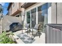 Cozy outdoor patio featuring a grill, comfortable seating, and privacy fence at 5312 Sylvester Loop, Tampa, FL 33610