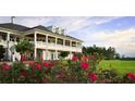 Elegant clubhouse with a covered balcony, surrounded by a well-manicured lawn and landscaping at 5513 Creek Ridge Rd, Brooksville, FL 34601