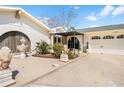 Charming front entrance featuring decorative statues, lush landscaping, and a covered porch for added curb appeal at 8518 Delaware Dr, Weeki Wachee, FL 34607