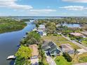 Breathtaking aerial view of waterfront home on the water, community, and stunning landscaping at 8759 Orient Ne Way, St Petersburg, FL 33702