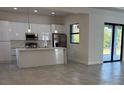 Bright, open-concept kitchen with stainless steel appliances and a spacious center island at 9 Tee View Rd, Rotonda West, FL 33947