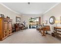 Spacious living room featuring stylish furnishings, large windows, and sliding doors that lead to a private pool at 9408 Bluebird Dr, Tampa, FL 33647