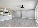 Spacious living room featuring hard surface floors and modern ceiling fans at 10047 41St N St # 10047, Pinellas Park, FL 33782