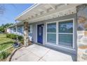 Close-up of a charming entrance with a blue door, stone accents, and ample natural light at 10447 110Th Ave, Largo, FL 33773