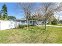 A charming single-story home featuring stone accents, well maintained lawn, and mature trees at 10447 110Th Ave, Largo, FL 33773
