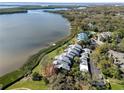 Stunning aerial view of waterfront condos, lush landscaping, and tranquil bay waters at 1111 N Bayshore Blvd # F11, Clearwater, FL 33759