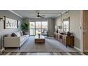 Bright living room features a comfortable sofa, ceiling fan, and sliding glass doors at 12055 3Rd E St # 103, Treasure Island, FL 33706