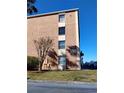 Exterior shot of building number 10 with well-maintained landscaping in front and visible parking at 12760 Indian Rocks Rd # 1066, Largo, FL 33774
