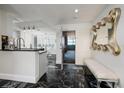 Stylish entryway with black marble floors, modern light fixtures, and a decorative mirror creates a sophisticated entrance at 1560 Gulf Blvd # 1104, Clearwater Beach, FL 33767