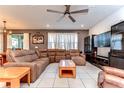 Comfortable living room featuring a large sectional sofa, TV and tile flooring at 17805 Everlong Dr, Land O Lakes, FL 34638