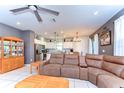 Open-concept living room with tile flooring and a comfortable sectional sofa at 17805 Everlong Dr, Land O Lakes, FL 34638