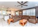 Spacious living room featuring tile flooring and a large sectional sofa at 17805 Everlong Dr, Land O Lakes, FL 34638