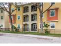 Multi-story apartment building with stucco facade, balconies, and decorative railings at 1810 E Palm Ave # 7104, Tampa, FL 33605