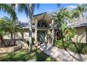 Inviting entrance with stone accents, arched window, and well-maintained landscaping at 3416 Fairfield Trl, Clearwater, FL 33761
