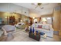 Bright living room featuring tile flooring and a decorative mirrored wall at 3416 Fairfield Trl, Clearwater, FL 33761