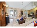 Cozy living room with French doors, tile floors, and neutral decor at 3416 Fairfield Trl, Clearwater, FL 33761