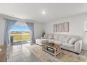 Bright and airy living room with sliding glass doors leading to the outdoors, perfect for entertaining at 35320 Spruce Knob Ct, Dade City, FL 33525
