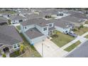 An aerial view showcases this lovely home, featuring an attached 2-car garage and manicured landscaping at 3774 Autumn Amber Dr, Spring Hill, FL 34609