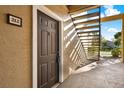 Exterior entryway featuring a brown door with the unit number and adjacent stairs leading upwards at 4006 Crockers Lake Blvd # 212, Sarasota, FL 34238