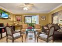 Cozy living room featuring comfortable seating and a sliding glass door with outdoor views at 4006 Crockers Lake Blvd # 212, Sarasota, FL 34238