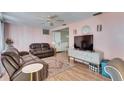 Cozy living room featuring comfortable couches, wood floors, and a television for entertainment at 4111 Moog Rd, Holiday, FL 34691