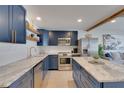 Well-equipped kitchen with island, stainless steel appliances, custom cabinets and stone countertops at 423 62Nd St, Holmes Beach, FL 34217