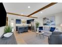 Inviting living room open to the kitchen with tile floors, recessed lights, and wood beam at 423 62Nd St, Holmes Beach, FL 34217